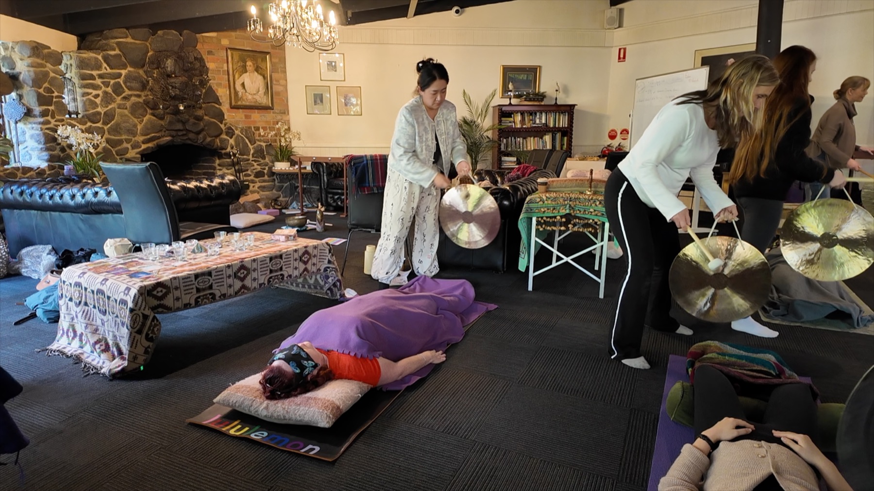 Workshop participants experiencing sound healing with gongs